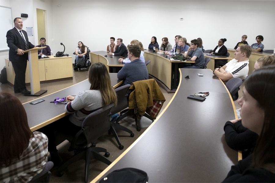 A judge speaks to a class in Hyland Hall.